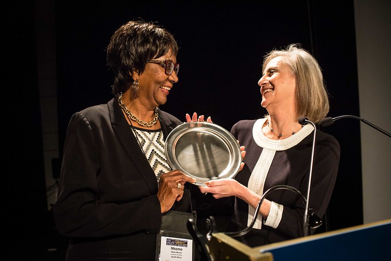 Stella Nkomo Accepts Her 2017 Lifetime Achievement Award from ILA President Cynthia Cherrey during a plenary session at ILA's 2017 global conference in Brussels