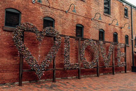 Distillery District. Old Brick Building with word Love on it in plants